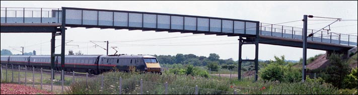 GNER class 91 under the footbridge at Crown Lakes in 2001