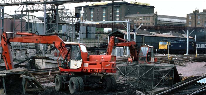 A class 47 comes into Kings Cross as diggers work on the new layout