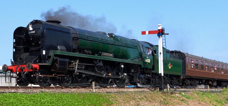 34028 Eddystone into Weyboure railway station on Sunday 16th April 2023.