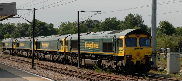 four Freightlinner class 66s with class 66515 at this end and 66595 and 66512 and 66518 leading all heading for March at Peterborough station
