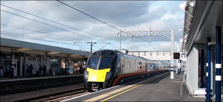 A class 180 not stopping at Peterborough comes though platform 3 on what is still the up fast.