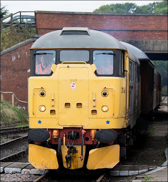 Class 31108 comes under the A1 road bridge and into Wansford on a train from Yarwell